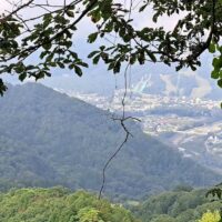 白馬の町やジャンプ台が見える。谷の反対側は菅の集落