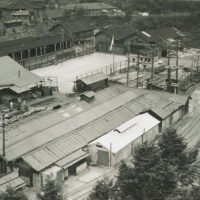 東平電車発着場。手前に整備工場と電車庫。奥に木工所。広場は体操、テニス、バレーボール等多目的に使用され、盆踊りも行われた。